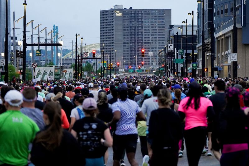 Participants start their running course during the 27th annual Flying Pig Marathon, Sunday, May 4, 2025, in Downtown Cincinnati.