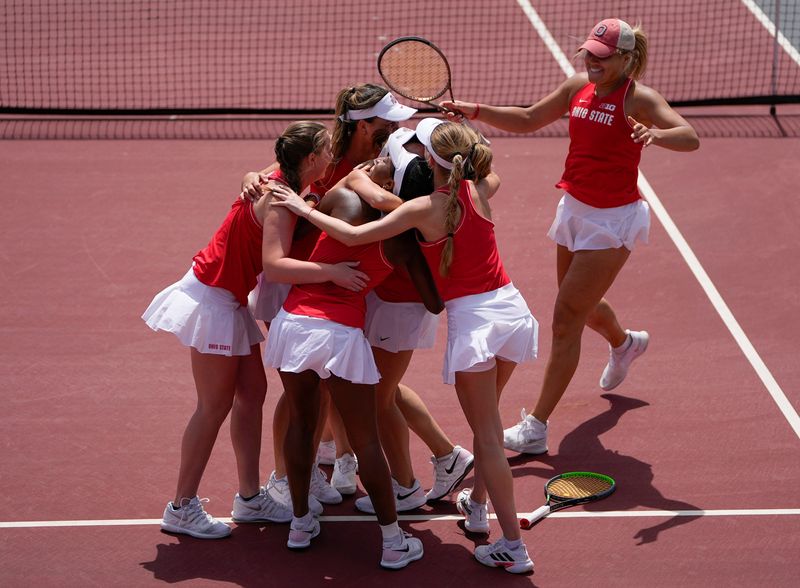 Members of the Ohio State Buckeyes women's tennis team run to congratulate Irina Cantos Siemers after she defeated Rutgers' Tess Fisher in the No. 1 singles match to clinch the Big Ten Conference title in Columbus on April 24, 2022.