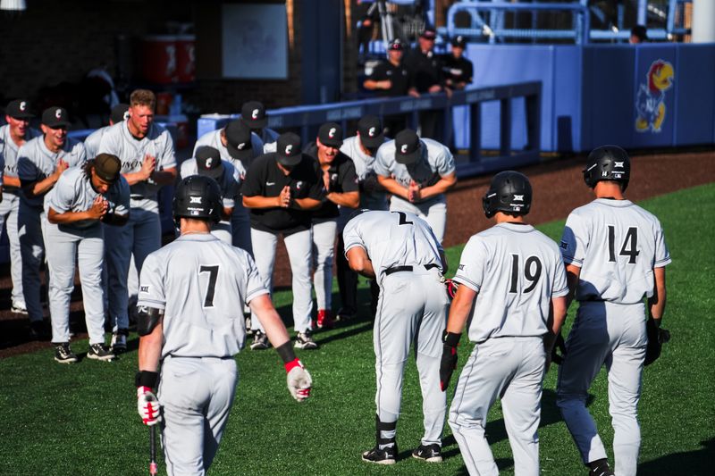 Kerrington Cross is greeted after one of his three homers against Kansas May 3. UC swept the Jayhawks May 2-4.