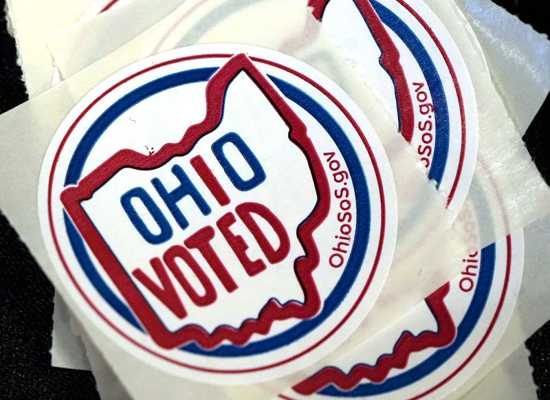 Election stickers rest on a voting machine in the polling place at the Highland Square Library on Tuesday, May 6, 2025 in Akron.