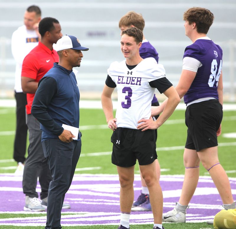 Elder sophomore Kaden Estep talks to a college coach during the Greater Cincinnati Catholic Combine football showcase at Elder High School's The Pit, May 8, 2025.
