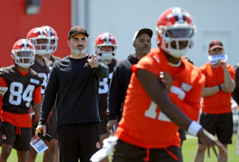 Cleveland Browns coach Kevin Stefanski watches quarterback Shedeur Sanders (12) participate in drills during day two of NFL rookie minicamp at the Cleveland Browns training facility May 10, 2025, in Berea, Ohio.