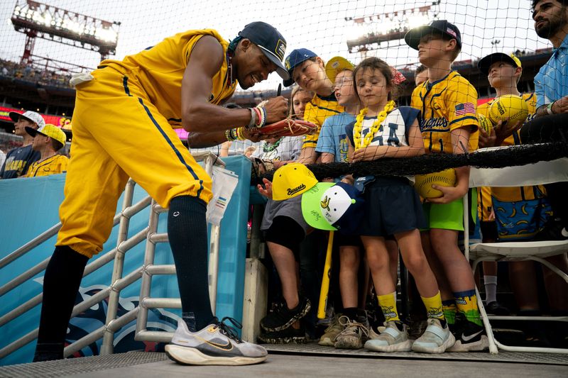 Savannah Bananas Maceo Harrison signs autographs before a game in Nashville.