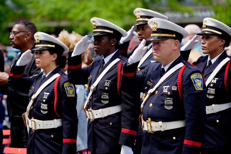 The Cincinnati Police Department Honor Guard stand and salute during the annual Police Memorial Ceremony and Parade in downtown Cincinnati on Monday, May 12, 2025.