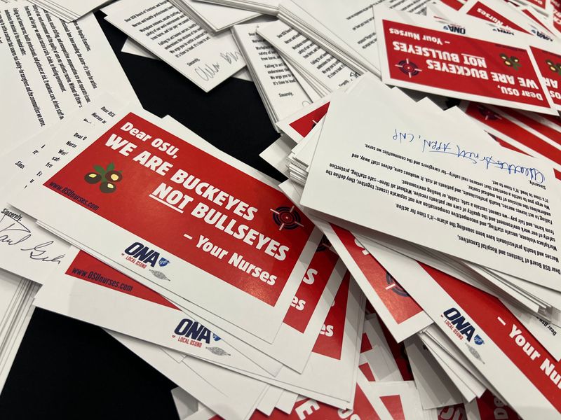 Dozens of nurses and other health care staff from the Ohio State University Wexner Medical Center protested at the university's quarterly board of trustees meeting on May 21 at the Longaberger Alumni House, demanding better staffing and enhanced workplace safety. Members of the Ohio State University Nurses Organization delivered stacks of postcards to trustees addressing their concerns.