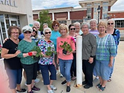 Altrusa Club members planted flowers in the light hanging baskets in downtown Marion.