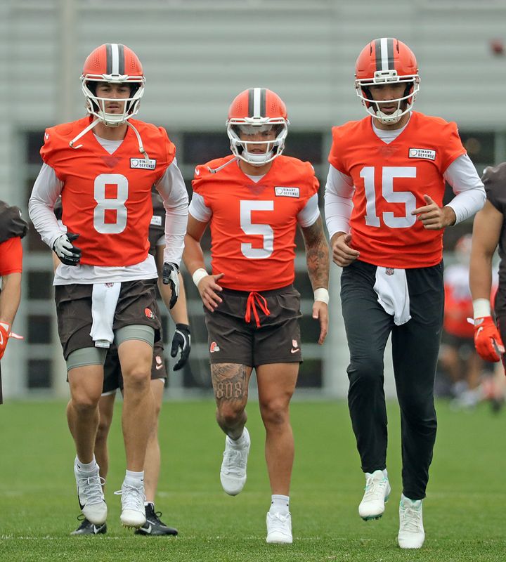 Cleveland Browns quarterbacks Kenny Pickett, left, Dillon Gabriel, center, and Joe Flacco warm up during an practice at the Browns training facility May 28, 2025, in Berea, Ohio.