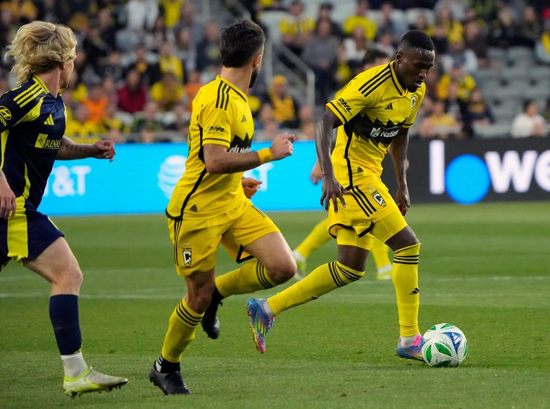 Crew forward Ibrahim Aliyu dribbles the ball past Nashville SC midfielder Edvard Tagseth in the first half of their MLS game May 28 at Lower.com Field.