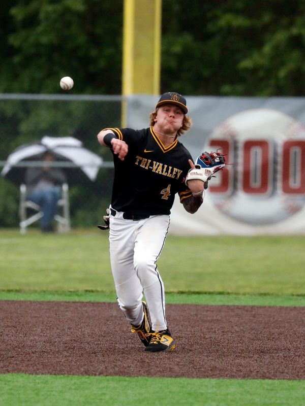 Kade Hindel, of Tri-Valley, throws out a runner at first base during a 6-4 loss to Dover in a Division III district semifinal on Wednesday, May 28, 2025, at Dover City Park. Hindel was named to the All-Ohio Division III Second Team by the OHSBCA.