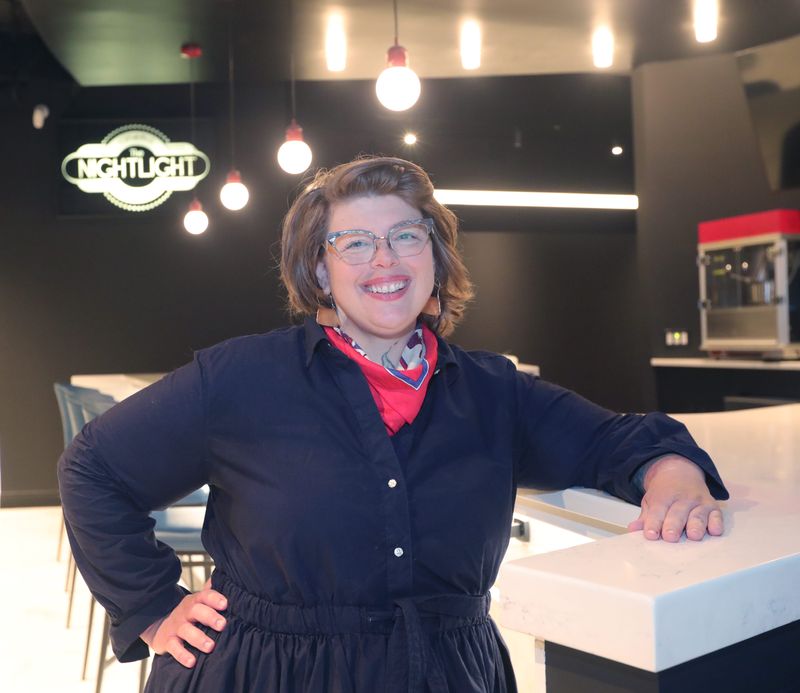 Jenn Kidd, executive director of The Nightlight movie theater, shows the newly expanded bar.