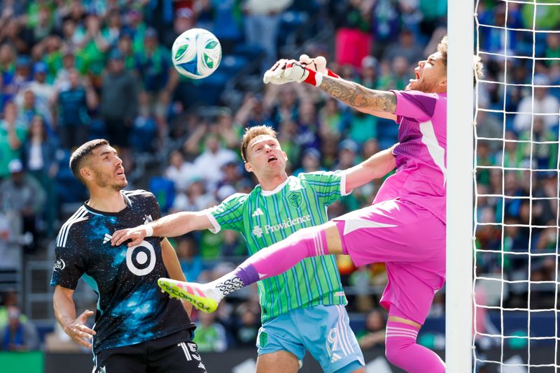 June 1: Minnesota United goalkeeper Dayne St. Clair (97) knocks a potential header away from Seattle Sounders FC's Danny Musovski (19) during the first half at Lumen Field. Minnesota United won the game, 3-2.