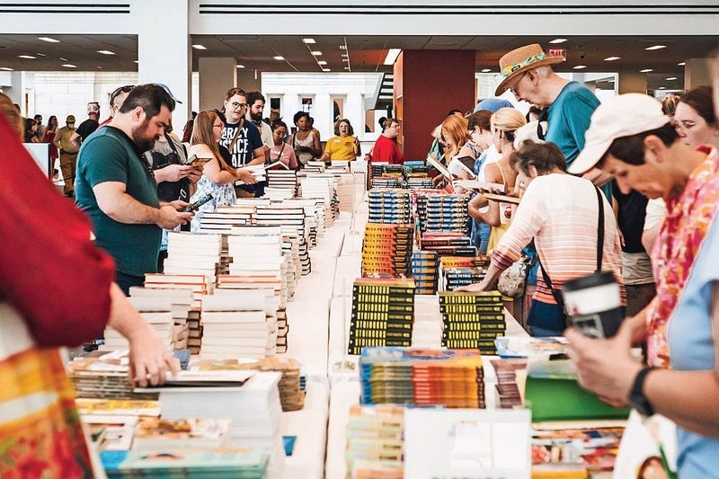 Attendees browse tables at the 2024 Columbus Book Festival, organized by the Columbus Metropolitan Library.