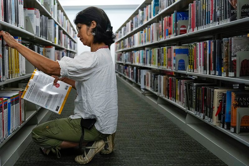 Utpola Borah of customer service shelves books at the Columbus Metropolitan Library on Wednesday, June 4, 2025 in Columbus, Ohio.