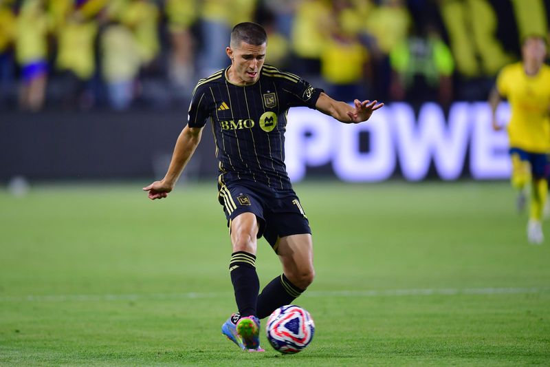 May 31, 2025; Los Angeles, California, USA; LAFC defender Sergi Palencia (14) passes the ball in the second half against Club America during a playoff match of the 2025 FIFA Club World Cup at BMO Stadium. Mandatory Credit: Gary A. Vasquez-Imagn Images