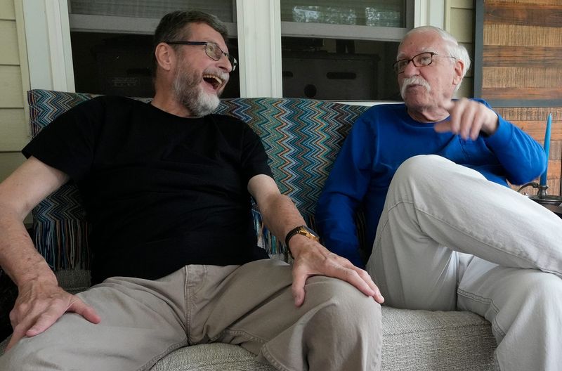 Edward Lee Evans, left, and Bill Hoover share a laugh as they talk during an interview at their West Akron home about their gay rights activism, marriage and upcoming 50th anniversary party.