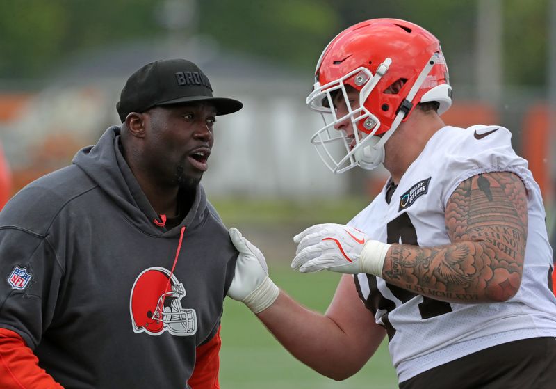 Cleveland Browns defensive line coach Jacques Cesaire, left, works with defensive tackle Mason Graham during practice at minicamp June 10, 2025, in Berea, Ohio.