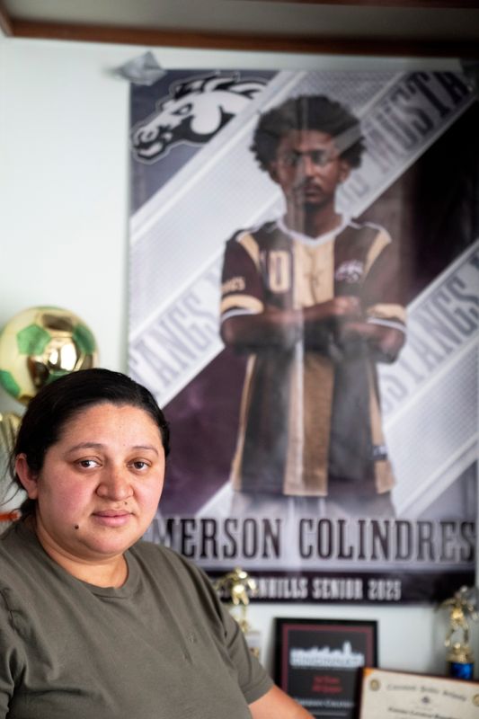 Ada Bell Baquedano-Amador stands next to a poster of her son Emerson Colindres at their home in Cheviot on June 11, 2025.