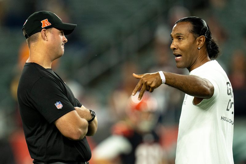 T.J. Houshmandzadeh, forner Bengal, speaks to Cincinnati Bengals head coach Zac Taylor before the NFL game at Paycor Stadium in Cincinnati on Monday, Sept. 23, 2024.