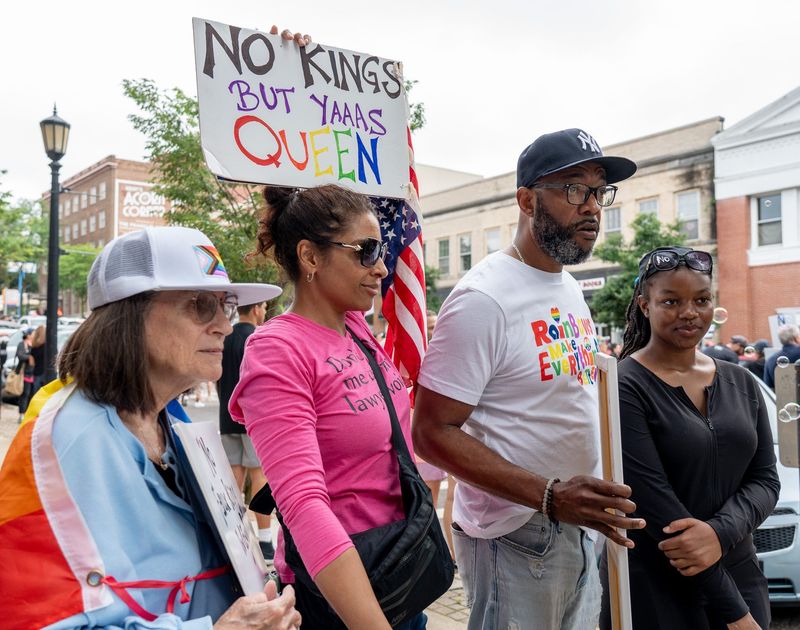 Lani Sherwood, Addisah Sherwood, Cedric Marshall and his daughter Bristyn Marshall, 15, at the No Kings protest in Kent, Ohio, on Saturday, June 14, 2025.