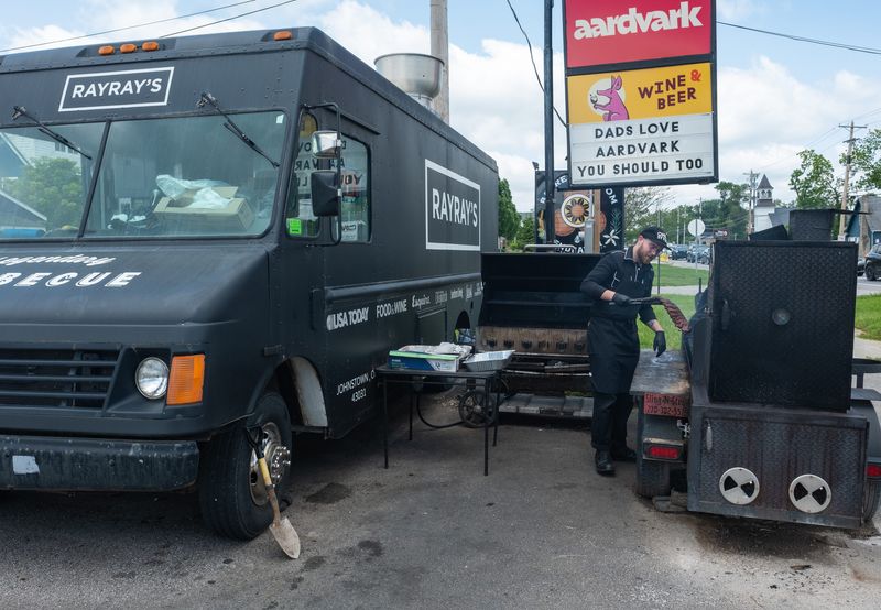Emerson Kay works the grill at the Ray Ray's food truck, parked in front of Aardvark Wine and Beer. Ray Ray's and Aardvark both won multiple Best of Columbus categories in 2025.