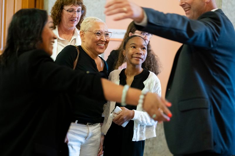12-year-old Avery Russell of Columbus, celebrates with her family and State Rep. Kevin Miller R-Newark, after the Ohio House approved a bill to revamp the state's dangerous dog laws on June 18. Avery's Law, named after Avery Russell, would require owners of dangerous dogs to purchase $100,000 in liability insurance and lock their dogs away when people visit their property. The bill would also require euthanasia of a dog that kills or seriously injures a human being. The legislation still needs to clear the Ohio Senate before it'll be sent to the governor.