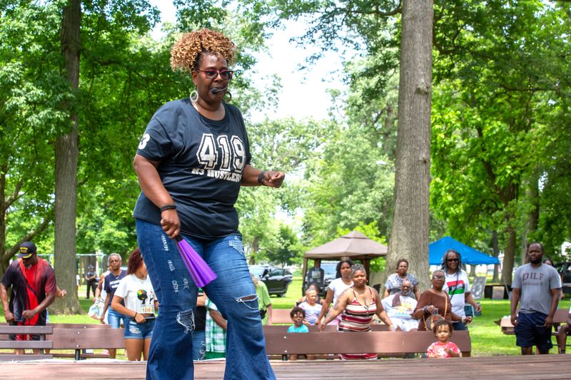 Waverley Hawkins, of Toledo, leads the group in a line dance, during Fremont's Juneteenth Community Celebration, held at Birchard Park on June 21.