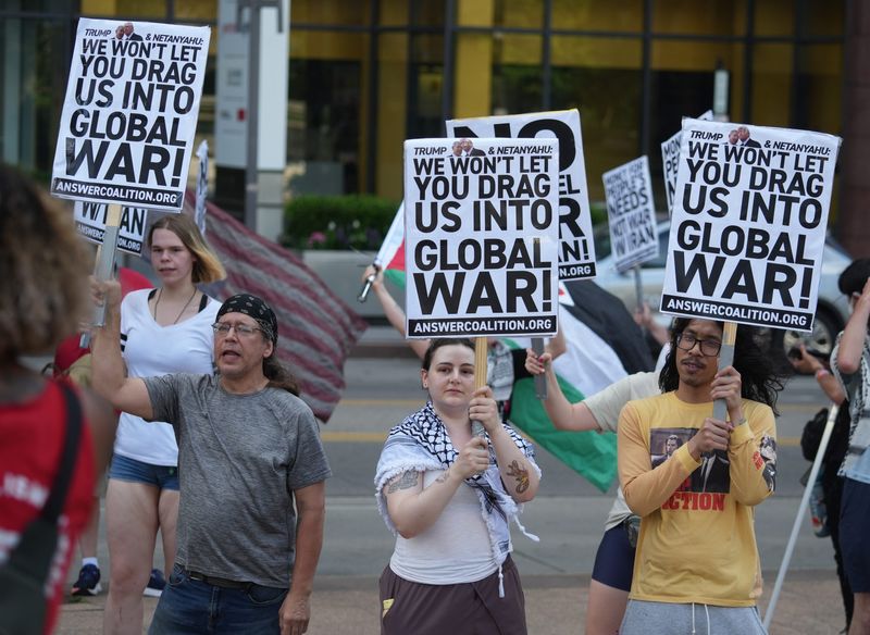 Attendees listen to speakers at the Stop the War on Iran protests planned by the ANSWER Coalition and others at the Ohio Statehouse in Columbus on June 22, 2025.