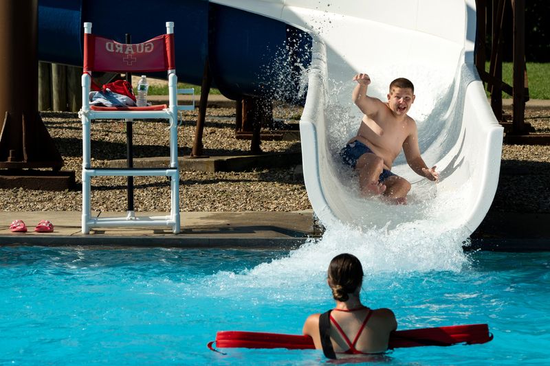Tyler Koons of Lancaster, Ohio, shoots out of the waterslide into the water at Tiki Pool on June 23, 2025, in Lancaster. Temperatures will be around 90 degrees this week, but the added heat index will push those temperatures to feel above 100 degrees.