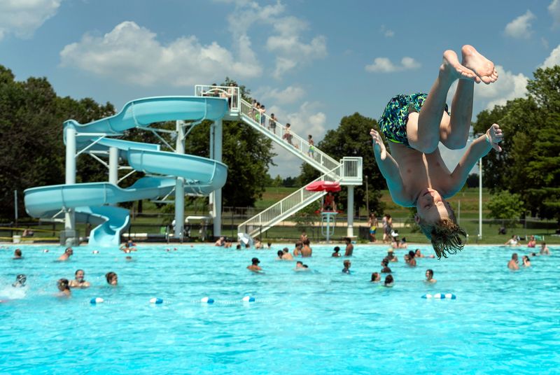 Luke Barker, 9 of Chillicothe, does a front flip off of the diving board at the Donald M. Smith Memorial Swimming Pool in Yoctangee Park on June 24, 2025, in Chillicothe, Ohio.