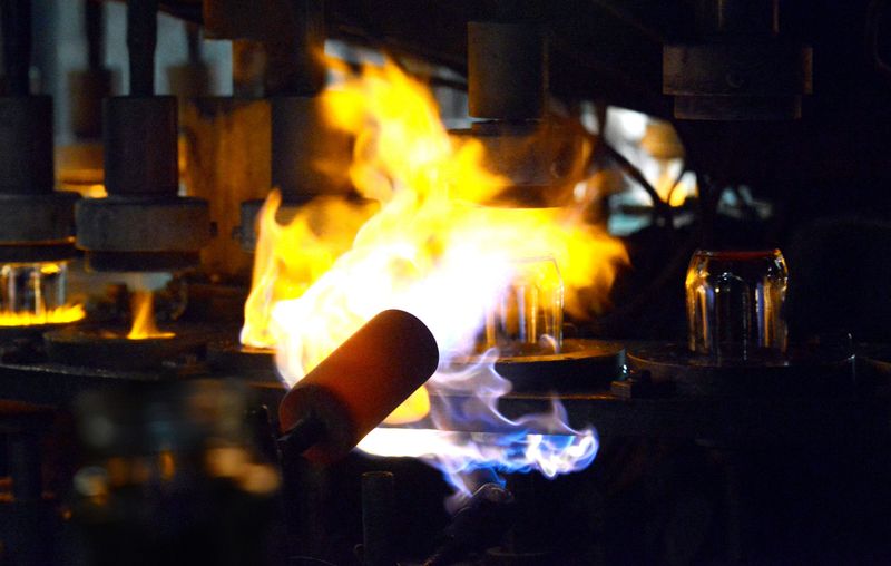 Flames shoot out to hit freshly pressed drinking glasses Tuesday, June 7, 2016, in the Anchor Hocking manufacturing in Lancaster.