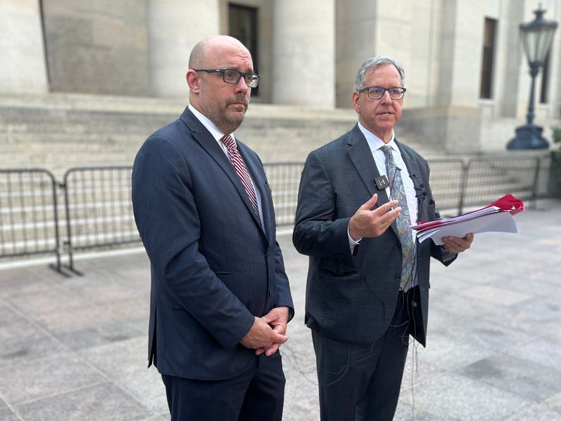 Former state Rep. Jeff Crossman and former Ohio Attorney General Marc Dann speak to reporters outside the Ohio Statehouse on June 25 about their plan to sue over the state's use of unclaimed funds for the new Browns stadium.