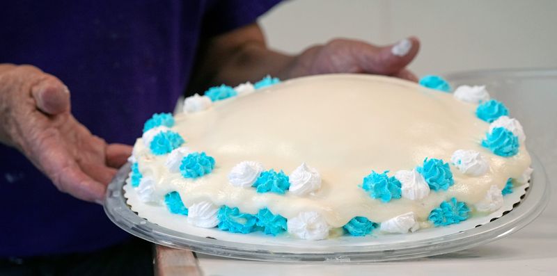 Dan Durbin of Durbin’s Magic Freeze holds up one of the ice cream cakes that was ruined by a recent power outage June 25 in Barberton.