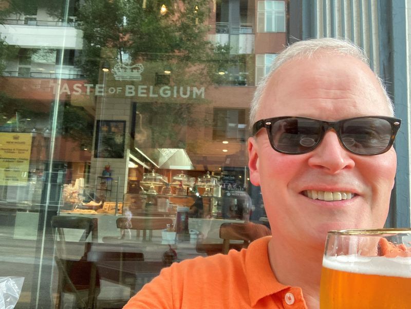 Business reporter Alex Coolidge sitting outside Taste of Belgium in Over-The-Rhine.