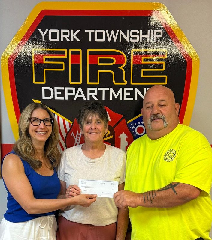 Linda Bullock presented a check for $1,500 to the York Twp Fire Department in honor of her late husband Pat Bullock, who was a volunteer firefighter there. Bullock is the manager at Nelsonville Homes, one of the properties managed by Fairfield Homes. Pictured are Jennifer Gorsuch Walters, President, Fairfield Homes, Inc., Linda Bullock, Manager, Nelsonville Homes and Scott McManus, Fire Chief, York Twp Fire Department.
