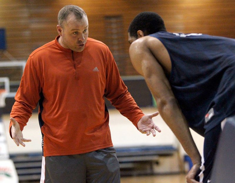 Chet Feldman encourages University of Akron center Zeke Marshall during a basketball workout April 10, 2013.