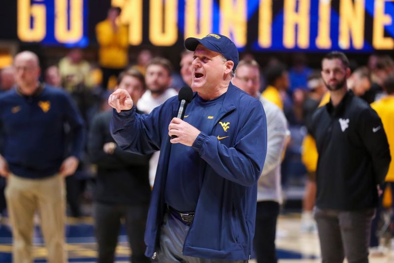 Feb 19, 2025; Morgantown, West Virginia, USA; West Virginia Mountaineers head football coach Rich Rodriguez speaks to the crowd during a timeout during the first half against the Cincinnati Bearcats at WVU Coliseum. Mandatory Credit: Ben Queen-Imagn Images