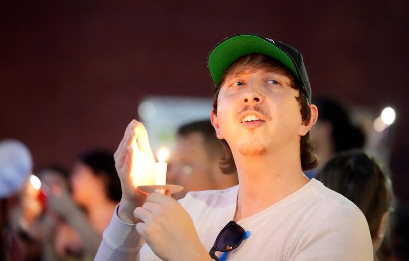 Javier Arranz of Canton holds a candle during a benefit event and vigil in July 2025 for Ryan "JJ" Godbey at Darlin's CREW in Canton.