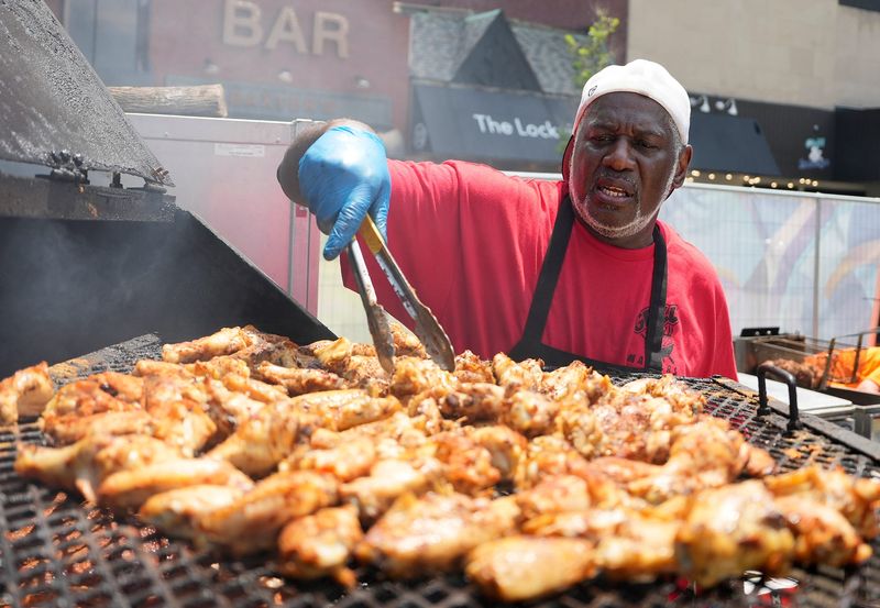 Donny Teague, pit master for Grill Masters, tends to his chicken wings on the first day of The Heart of Akron Festival at Lock 3 in Akron on July 3, 2025.