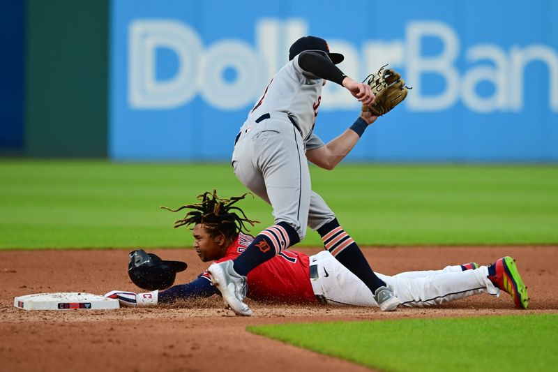 Jul 5, 2025; Cleveland, Ohio, USA; Cleveland Guardians designated hitter Jose Ramirez (11) steals second base as Detroit Tigers shortstop Trey Sweeney (27) goes for the throw during the fourth inning at Progressive Field. Mandatory Credit: Ken Blaze-Imagn Images