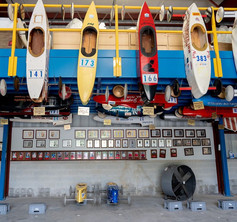 Soap Box Derby Hall of Fame museum has the winning cars of past races along the walls, along with portraits of the winners, and the current cars are lined up on the floor of the building on July 7.