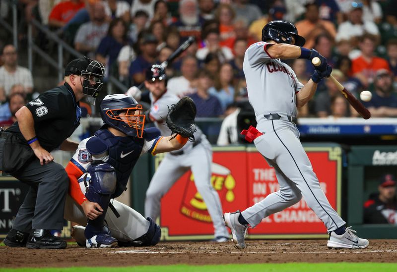 Cleveland Guardians' Steven Kwan hits a RBI line drive off the head of Houston Astros starting pitcher Colton Gordon (not pictured) on July 7, 2025, in Houston, Texas.