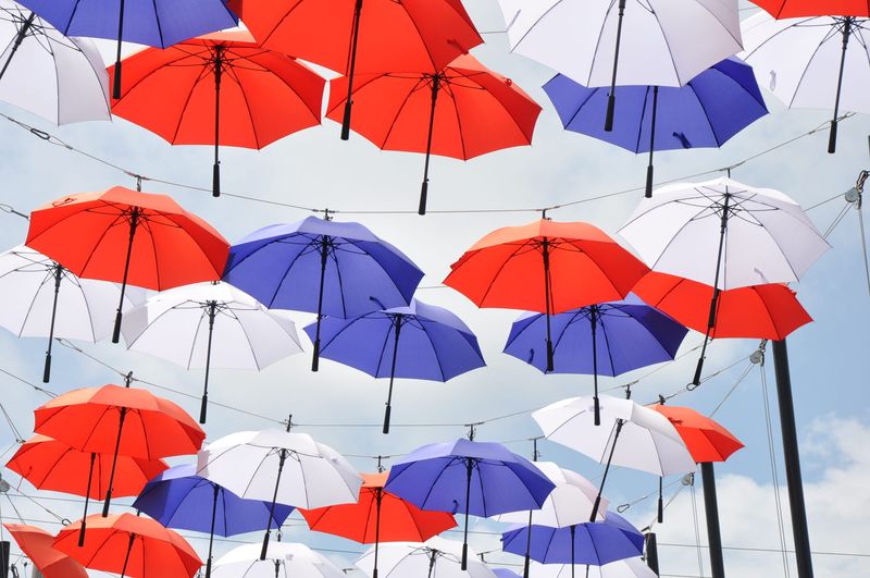 The "America 250" exhibit at Umbrella Alley in Louisville includes 138 red, white and blue umbrellas.