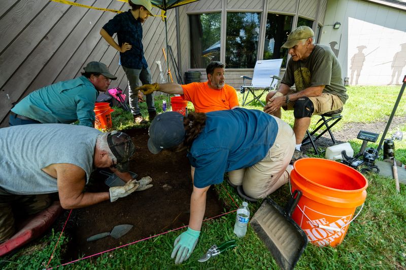 Jonathan Brewster, center in orange, an archaeologist with Ohio History Connection, talks with Doug Angeloni, right, a volunteer and trustee of Friends of Fort Laurens Foundation, during the excavation process of Fort Laurens outside of Bolivar on July 8, 2025,. Their work is in preparation for the partial reconstruction of Ohio's only Revolutionary War fort. It is expected to be completed by 2028, which is the 250th anniversary of the establishment of Fort Laurens. Also pictured, clockwise from bottom left are Danny Frame, a volunteer from Canton who participated in a dig at the fort in 1972; Peter Ellis, crew chief from Pittsburgh; Owen DeMali, archaeological field technician from Akron; and Hope Scott, an archaeological field technician from Zanesville.