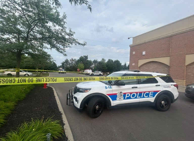 Columbus police cruisers and crime scene tape were used to block off the area where a male who was mortally wounded by a shooting at a nearby apartment complex drove his vehicle into a tree line on the southeast side of the Target store at Polaris Parkway, where the shooting was reported about 6:10 p.m. Responding officers found the male with at least one gunshot wound. Medics pronounced him dead at the scene.