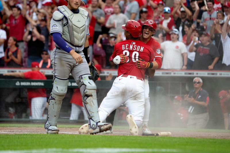 Will Benson gets a big hug from TJ Friedl after scoring from third base on ground ball off the bat of Noelvi Marte for the winning run in the Reds' 4-3 walk-off victory over the Colorado Rockies Saturday, July 12. Benson had tripled in Spencer Steer for the game-tying run.