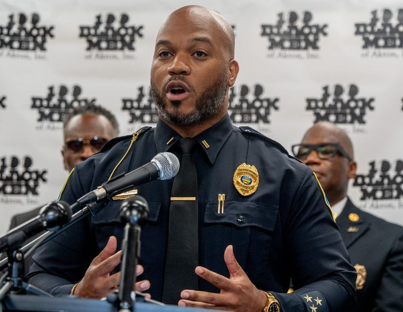 Akron Lt. Michael Murphy, a member of the 100 Black Men of Akron mentoring group, talks during a press conference July 14 at Mason Community Learning Cneter to address youth violence and mentorship solutions. Multiple teens and young adults were caught in the crossfire of an early-morning shooting last week in the school's parking lot.