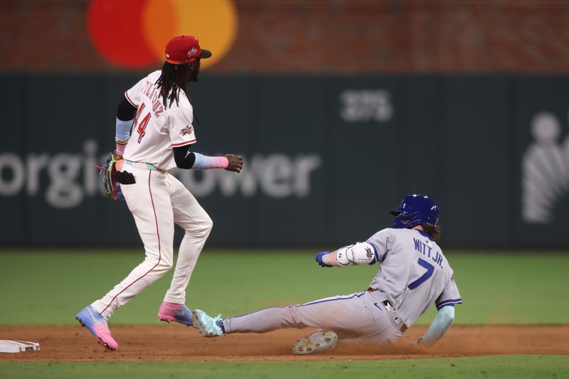 Elly De La Cruz awaits the throw from the outfielder as shortstop Bobby Witt Jr. of the Kansas City Royals slides in safely to second during the AL's ninth-inning, game-tying rally July 25.