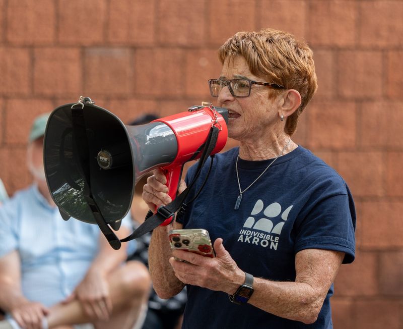 Lisa Schoenberg, with Indivisible Akron, speaks at the Good Trouble Lives On rally at Joy Park Community Center in Akron on July 17.