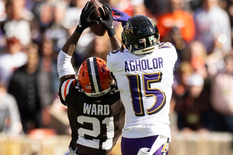Oct 27, 2024; Cleveland, Ohio, USA; Cleveland Browns cornerback Denzel Ward (21) breaks up a pass intended for Baltimore Ravens wide receiver Nelson Agholor (15) during the second quarter at Huntington Bank Field. Mandatory Credit: Scott Galvin-Imagn Images