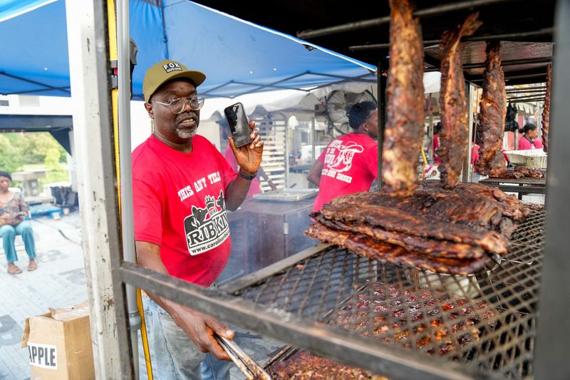 Solomon Williams of Carolina Rib King cooks ribs during Jazz & Rib Fest at West Bank Park on July 18 in Columbus.